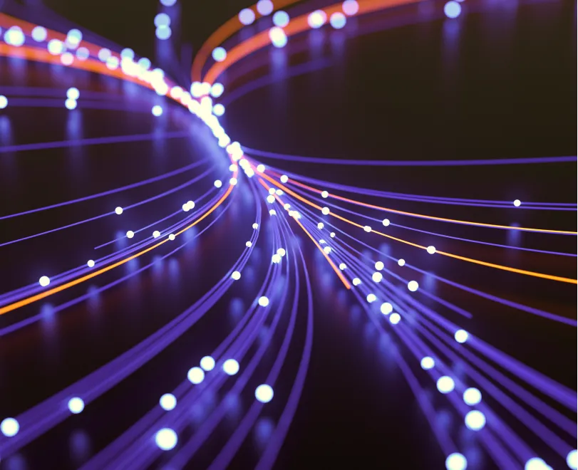 Abstract glowing fiber optic lines in purple and orange converging, representing data or network connections.